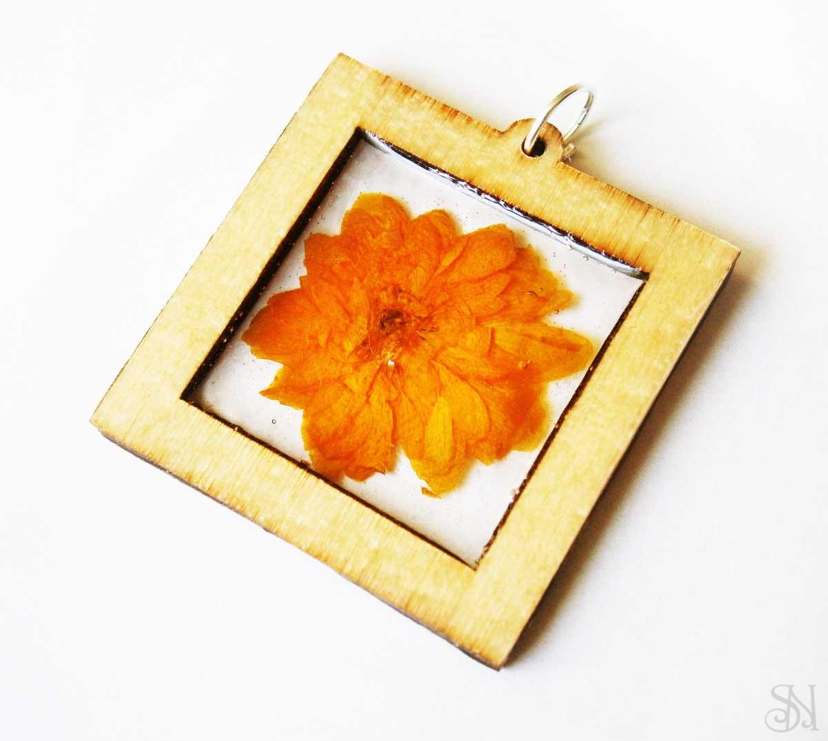 Handmade živicový prívesok s oranžovým kvetom v ráme